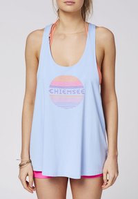 Light blue tank top with a round graphic featuring horizontal stripes in orange, pink, and purple. Loose fit with wide armholes.