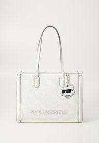 White tote bag with embossed patterns, dual handles, silver hardware, and a detachable cat-shaped charm wearing sunglasses.