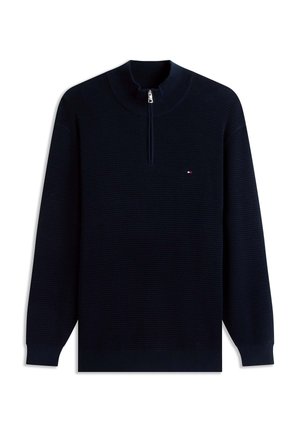 Pulover albastru marin cu mâneci lungi, cu dungi, fermoar de un sfert și un mic logo roșu, alb și albastru pe pieptul stâng.
