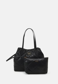 Set di borse nera trapuntata con hardware dorato. La borsa tote più grande ha manici doppi; la pochette più piccola presenta una chiusura a zip.