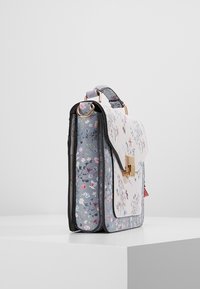 Floral-patterned structured handbag with blue and white panels, gold-tone clasp, top handle, and a rectangular shape on a white surface.