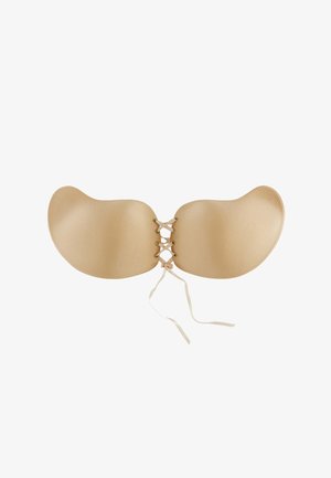 Reggiseno adesivo senza schienale di colore nude, con coppe morbide e arrotondate e centro laccato con nastri sottili. Texture morbida, design senza cuciture.