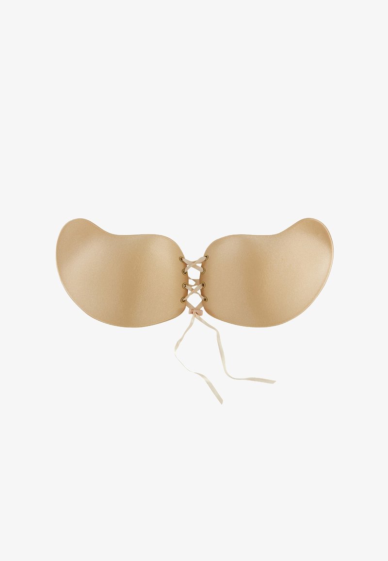 Reggiseno adesivo senza schienale di colore nude, con coppe morbide e arrotondate e centro laccato con nastri sottili. Texture morbida, design senza cuciture.