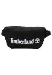 Banane en tissu noir avec une fermeture éclair sur le dessus et logo Timberland blanc avec emblème d’arbre à l’avant.