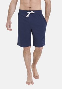 Shorts en coton bleu marine avec taille à cordon, poches latérales et coupe ample, idéaux pour une tenue décontractée ou pour se détendre.