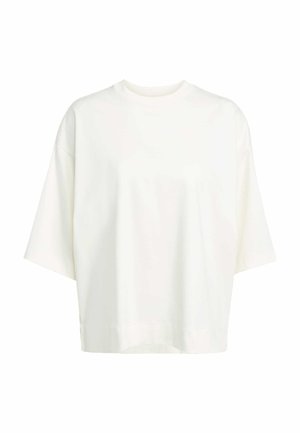 White oversized T-shirt made of soft cotton fabric. Features a crew neck, dropped shoulders, and a straight hem with subtle side slits.