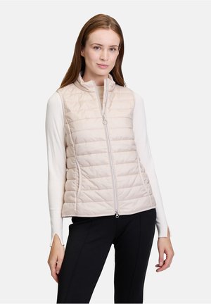 Light beige quilted vest with a high collar and zipper closure. Features horizontal stitching, smooth texture, and fitted design.