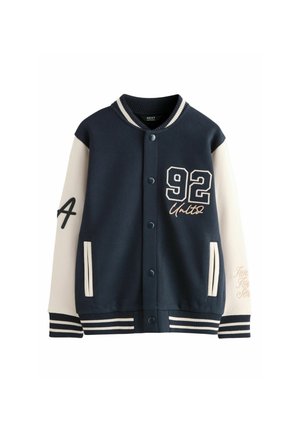 Navy blue and white varsity jacket with snap buttons, striped cuffs, number 92 on chest, letter A on left sleeve, and front pockets.
