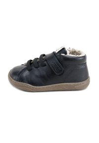 Zapatilla de cuero negra con un suave forro beige, sistema de cierre con cordones y tiras de Velcro ajustables. Cuenta con una suela de goma con un agarre texturizado.