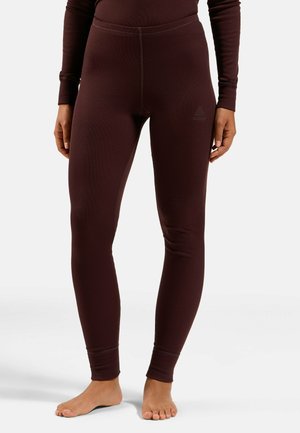 Burgundy leggings made from textured fabric, featuring a fitted design, elastic waistband, and minimal branding near the hip.