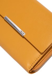 Yellow leather wallet with a smooth texture, featuring a silver metal accent and zip closure along the edge.