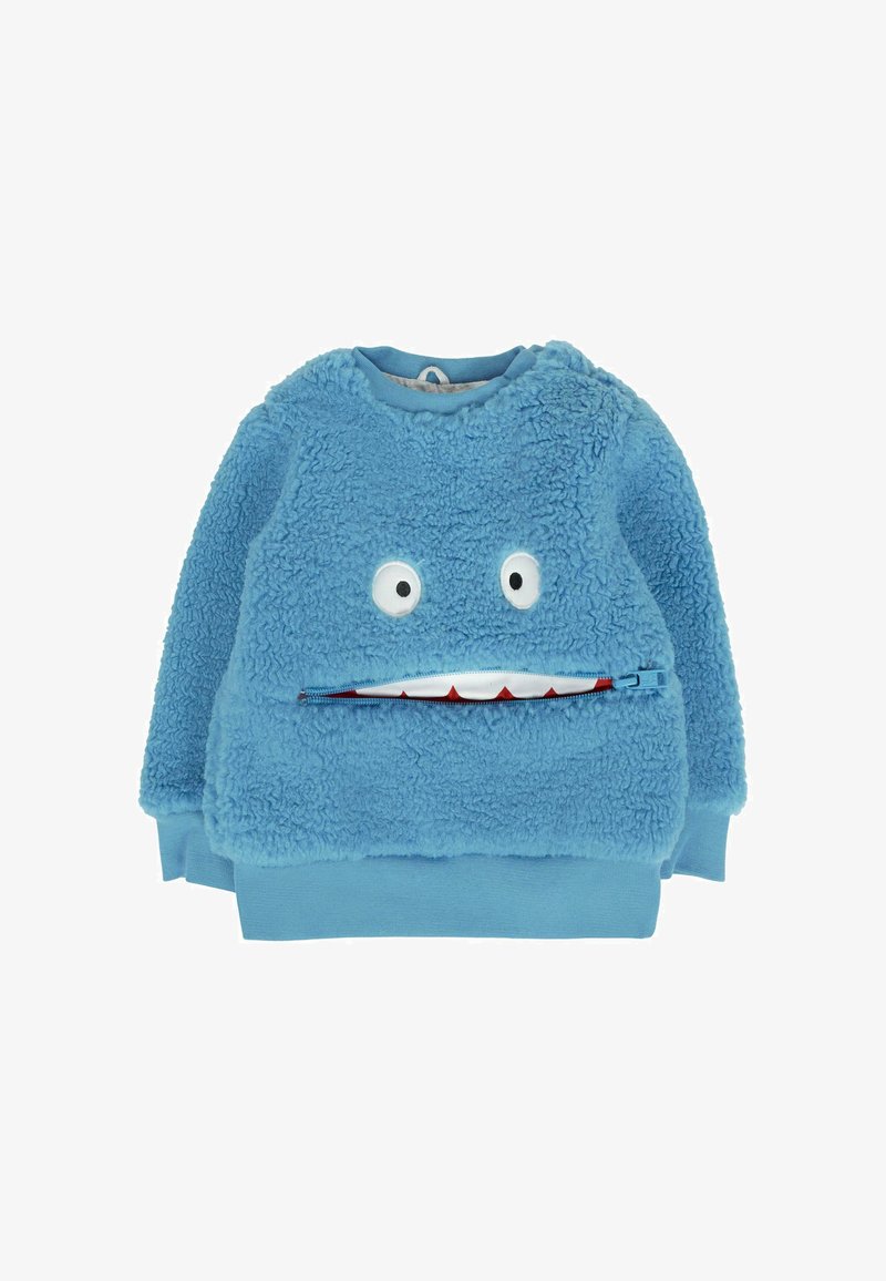 Pull en peluche bleu pour enfants avec deux yeux de dessin animé et un design de bouche zippée montrant des dents blanches avec des gencives rouges.