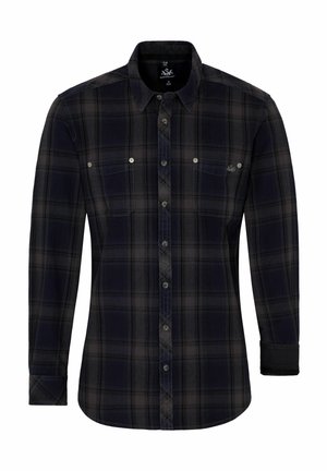Chemise en flanelle noir et à carreaux sombres, à manches longues, avec un devant à boutons, deux poches poitrine et un ourlet arrondi. Le tissu semble doux et texturé.
