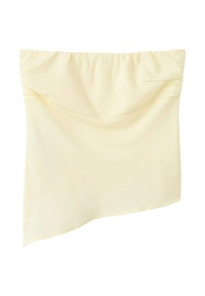 Kermanvärinen epäsymmetrinen putkikokotoppi, jossa on kerätty elastinen pääntie ja viistottu helma.