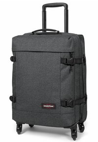 Černý látkový kufr na kolečkách v obdélníkovém tvaru, se dvěma bočními sponami, výsuvnou rukojetí a hladce se pohybujícími koly. Logo Eastpak na přední straně.