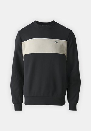Sweatshirt negru cu un panou orizontal bej, manșete și guler cu nervuri. Are un mic logo verde pe piept. Material din bumbac moale.
