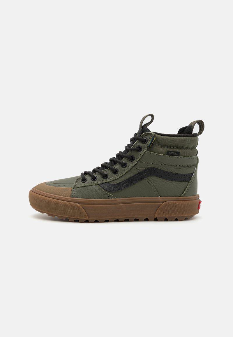 Høye sneakers med øvre del i grønn lerret, svarte detaljer, gummisåle og rund tå. Har snøring og opphengshempe på hælen.