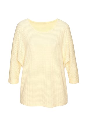 Waffelstrickpullover in Cremefarbe mit dreiviertel Ärmeln und Rundhalsausschnitt, lockere Passform, vor weißem Hintergrund dargestellt.