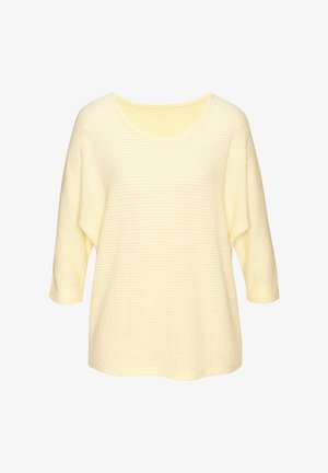 Waffelstrickpullover in Cremefarbe mit dreiviertel Ärmeln und Rundhalsausschnitt, lockere Passform, vor weißem Hintergrund dargestellt.