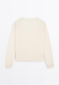 Cream-colored sweater with long sleeves, round neckline, and ribbed cuffs and hem. Smooth texture and minimalistic design, no patterns or embellishments.