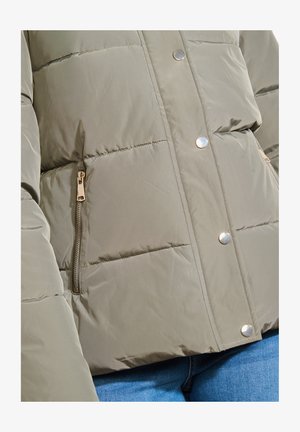 Olivgrüne Pufferjacke mit gesteppter Optik, metallischen Druckknöpfen und einer seitlichen Reißverschlusstasche. Angenehme Textur und robustes Material.