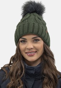 Knit green beanie with a textured design, featuring a large gray faux fur pom-pom on top and a branded leather accent.