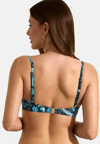 Bh met bloemenpatroon in donkerblauw, voorzien van verstelbare banden en een gouden hardware sluiting op de rug. Glad stofoppervlak.