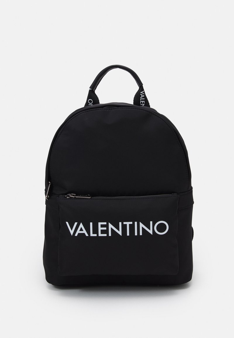 Black nylon backpack with a rounded shape, featuring a front zip pocket and prominent white "Valentino" logo. Includes dual top handles.