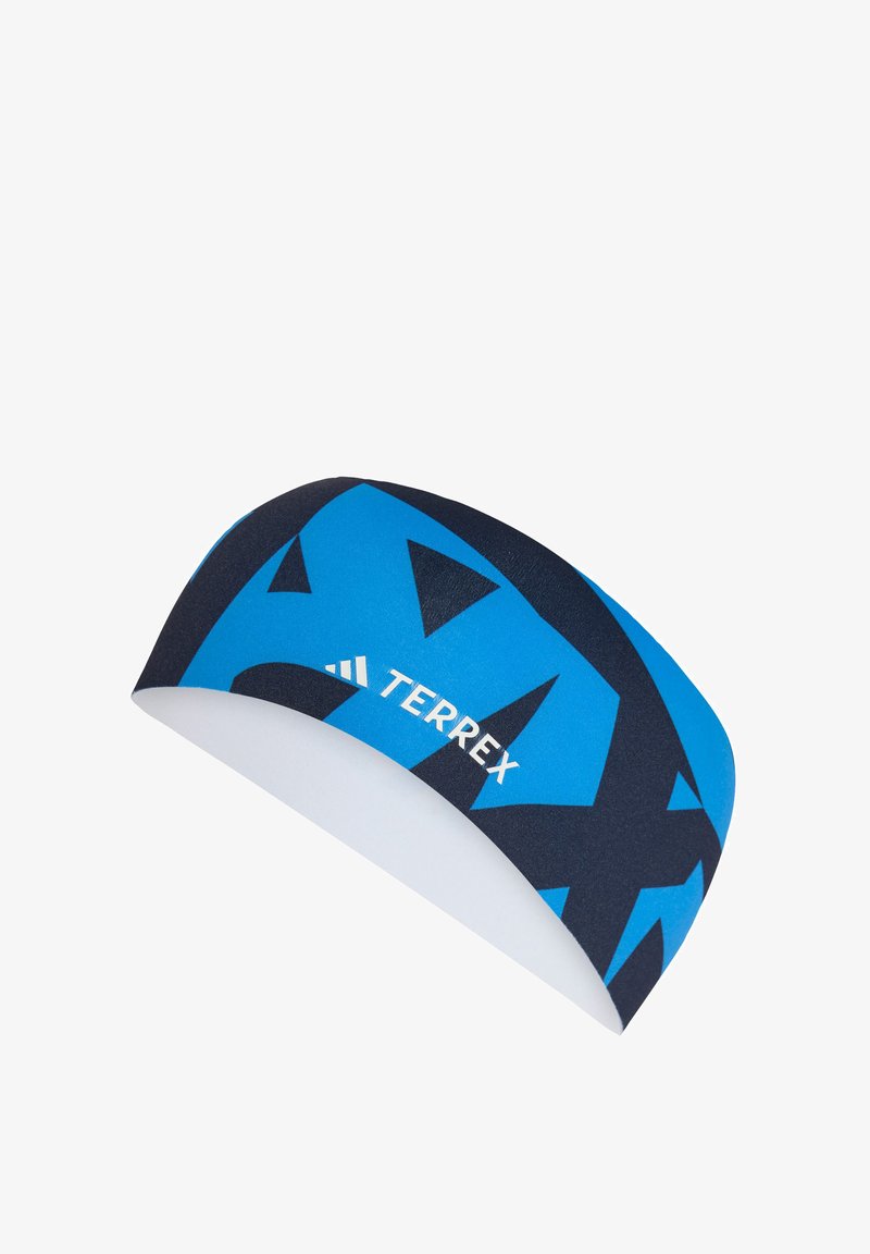 Cinta para la cabeza azul y negra con patrón abstracto, con el logo TERREX en blanco, hecha de tela elástica diseñada para ropa activa.