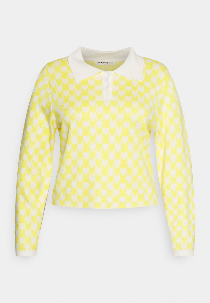 Pullover amarelo de malha com padrão de corações brancos, apresentando um colarinho branco e mangas compridas. Design cropped com fecho em botão.