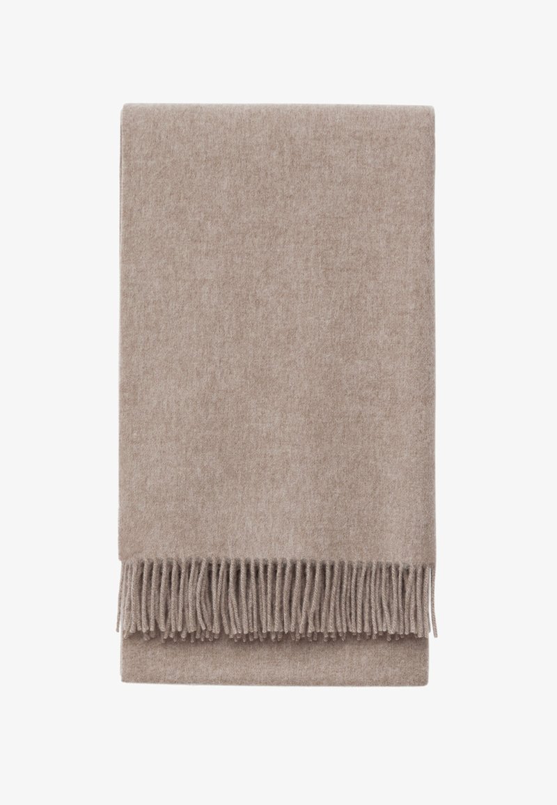 Beige Decke aus weichem Stoff, mit glatter Textur und langen Fransen entlang einer Kante abschließend.