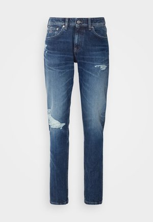 Denimjeans i en mörk tvätt med slitna detaljer, med rivna knän och rak benform. Metallknapp och nitar som accenter.