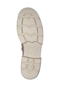 Sohle eines Schuhs mit einer weißen Gummibasis, einem ausgeprägten Profil und eingraviertem Logo, strukturiert für Griff und Stabilität.