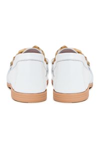 White leather shoes with a smooth finish, featuring a light brown rubber sole and a minimalist design. Rear view shows clean lines.