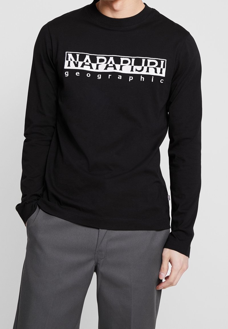 Long-sleeve black cotton t-shirt with white graphic text "NAPAPURI" and "geographic" across the chest. Crew neckline and fitted style.