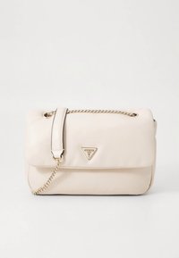 Cream-colored Guess handbag with gold chain strap and triangular logo on the front flap, set against a plain white background.