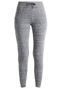 Šedé jogger kalhoty vyrobené z měkké, strukturované tkaniny. Mají elastický pás se šňůrkou a dvě postranní kapsy, u kotníků se zužují.