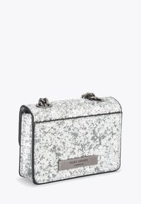 Sac d'épaule pailleté argenté avec une texture matelassée, une bordure noire et une plaque logo en métal argenté. Il comporte des sangles doubles en chaîne et une forme rectangulaire.