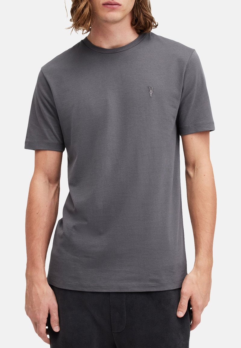 T-shirt grigio a manica corta in tessuto morbido con scollatura rotonda. Presenta un piccolo logo discreto sul petto sinistro. Design semplice e minimalista.