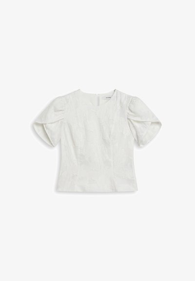 Blusa bianca con maniche corte a sbuffo, caratterizzata da un motivo floreale textures. Collo rotondo e chiusura con bottoni sul retro. Tessuto liscio.