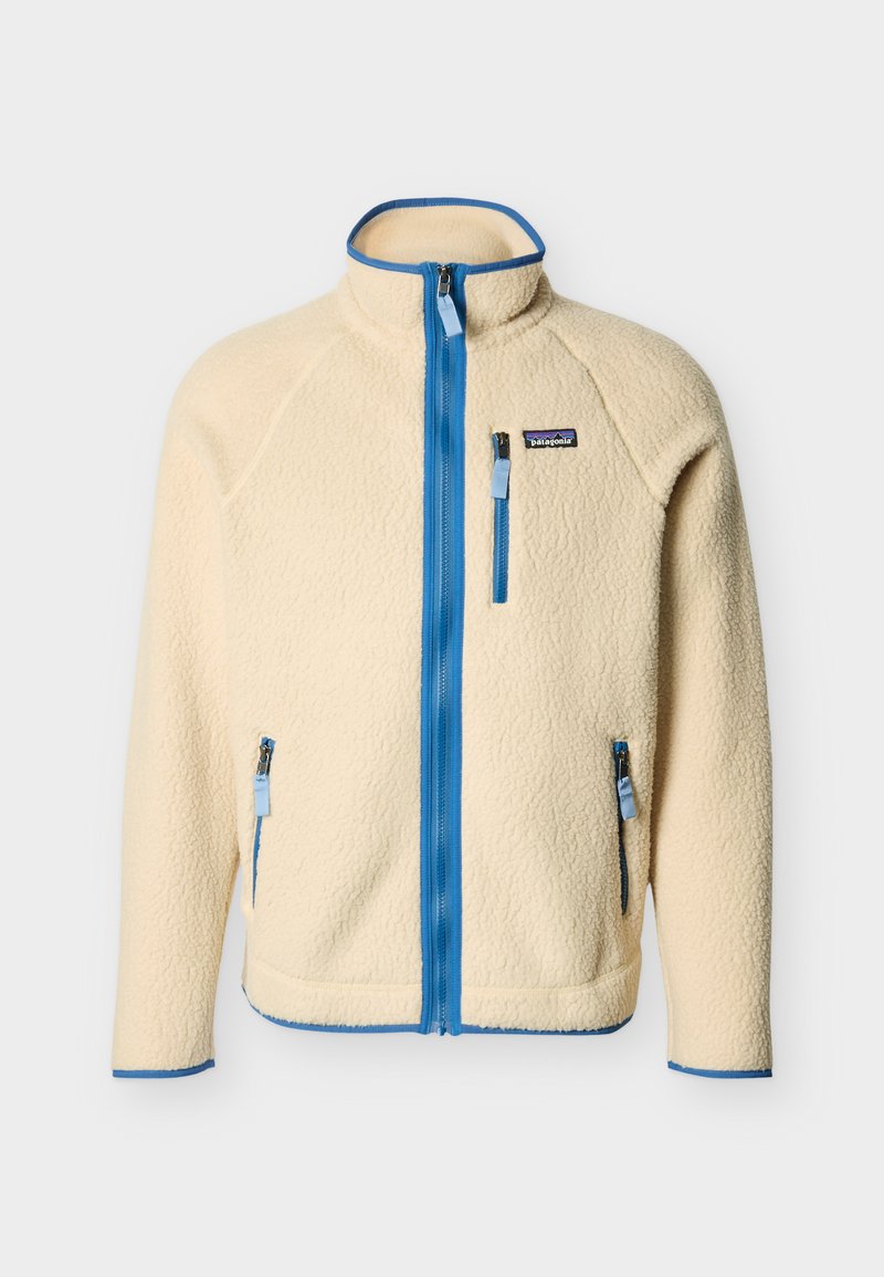 Veste en polaire crème avec fermeture éclair et bordure bleues, col montant, poches zippées poitrine et côtés, logo Patagonia sur la poitrine gauche.