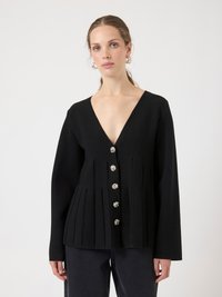 Black knitted top with a deep V-neck, pleated design, and decorative silver-tone buttons down the front. Long sleeves with a fitted silhouette.