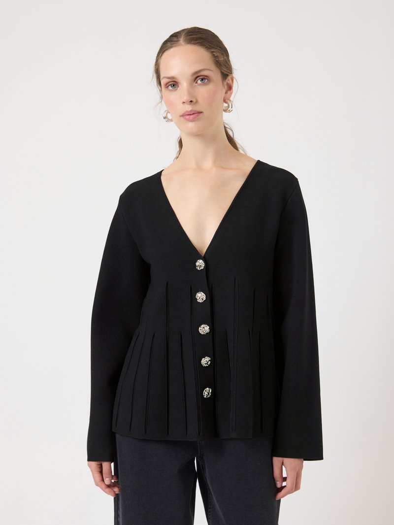 Black knitted top with a deep V-neck, pleated design, and decorative silver-tone buttons down the front. Long sleeves with a fitted silhouette.
