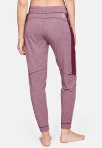 Bordové tepláky vyrobené z měkké, strukturované tkaniny; mají kontrastní boční panely a stažený pás s manžetou na lemu.