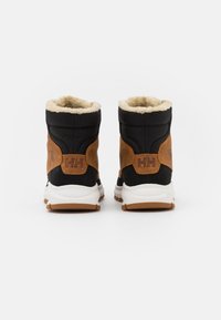 Boots with a black textile upper and brown leather accents, featuring a plush, cream-colored lining and a white midsole with a rubber outsole.