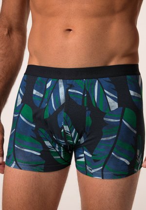 Boxers pour hommes en tissu bleu foncé avec des motifs de feuilles verts et blancs ; texture douce et ceinture élastique avec détail de logo.