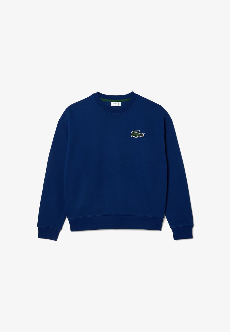 Sweat-shirt à col rond bleu marine avec manches longues et un petit logo de crocodile vert sur la poitrine gauche.