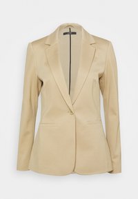 Blazer beige con chiusura a un pulsante, revers a punta e due tasche frontali. Realizzato in tessuto morbido con vestibilità sartoriale.