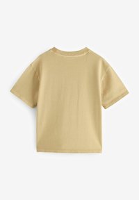 Ljusbeige kortärmad T-shirt i mjuk bomull. Har rund halsringning och en enkel, odekorerad design med en jämn textur.