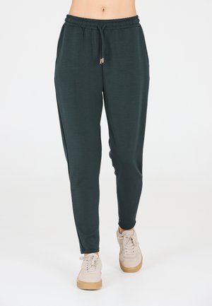 Donkergroene, lichte joggerpants met een elastische tailleband en trekkoord, voorzien van zijzakken en een tapered pootontwerp.
